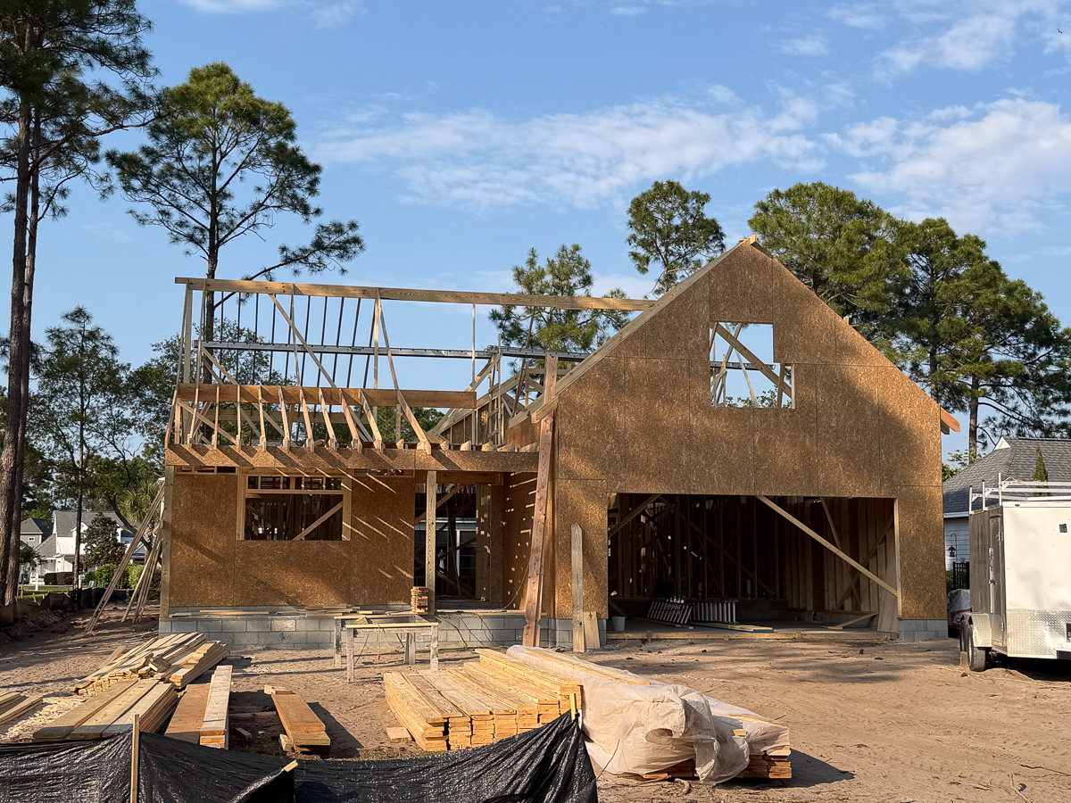 Two-story new construction with framed garage and gable ends in progress