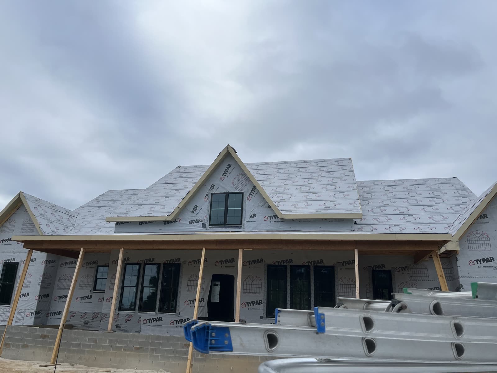 New coastal home exterior with Typar house wrap and covered front porch